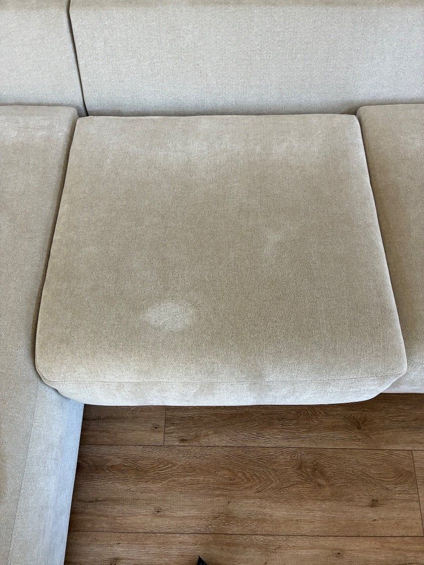Food stains and overall soiling on a family sectional cushion before cleaning in Mission Valley