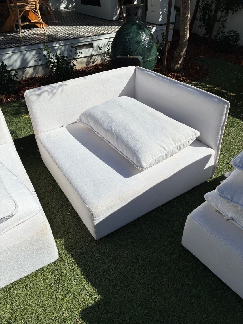 Cleaned white sectional couch module and cushion shown outdoors after upholstery cleaning in Pacific Beach