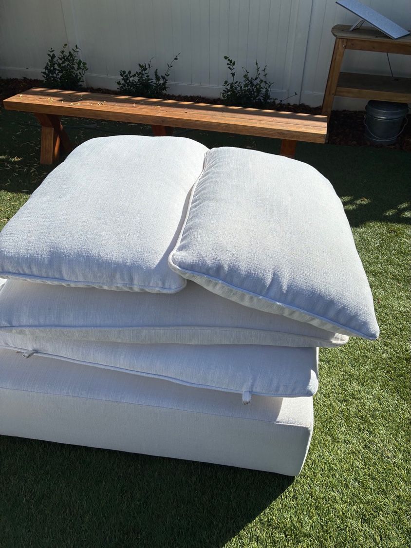 Cleaned white sectional cushions and components shown outdoors after upholstery cleaning in Pacific Beach