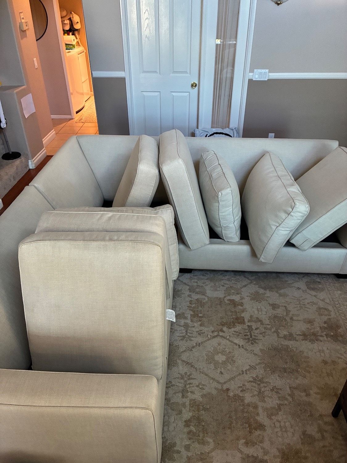 Light-colored family couch and cushions arranged after upholstery cleaning in Point Loma